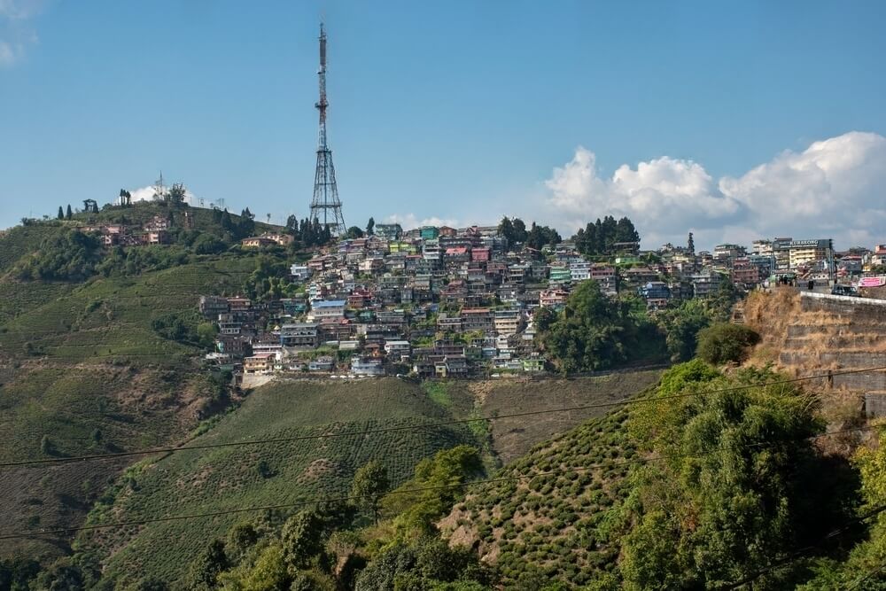 View of Kurseong tower surrounded by houses.