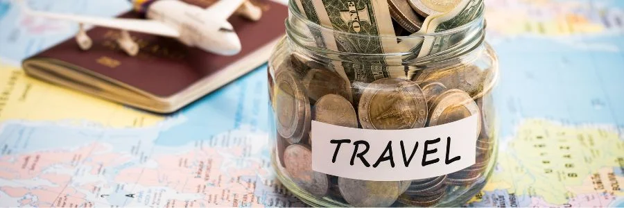 A jar full of coins with travel label on it.